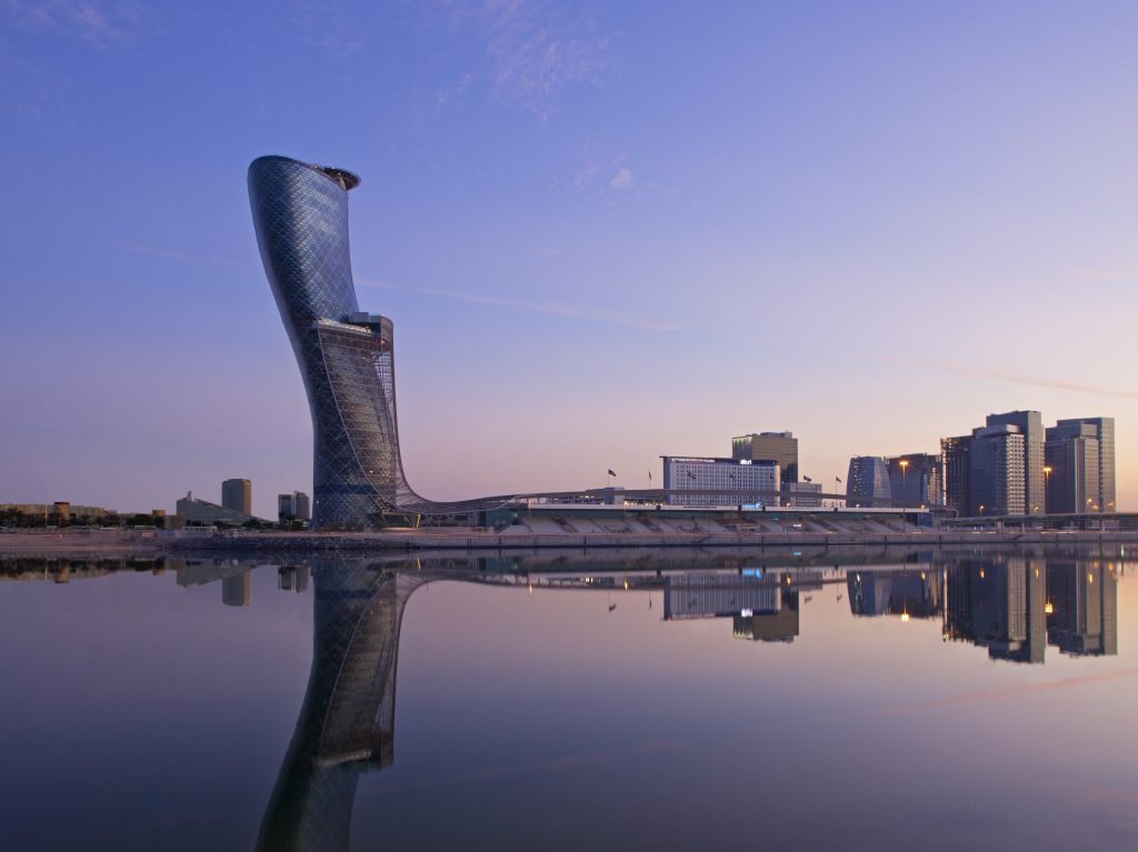 The blue Capital Gate Building reflects the sun off of its slanted exterior in Abu Dhabi, UAE