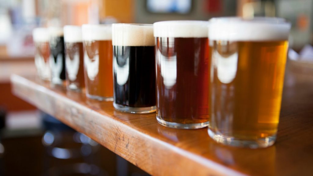 Seven different types of craft beers lined up for tasting