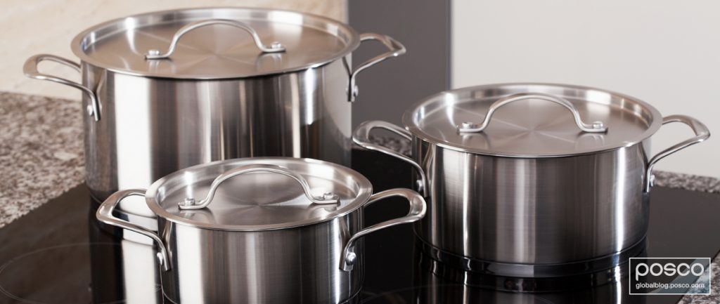 Three stainless steel pots on a stove top