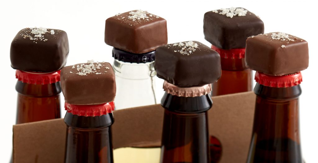 Chocolates placed on top of six bottles of beer