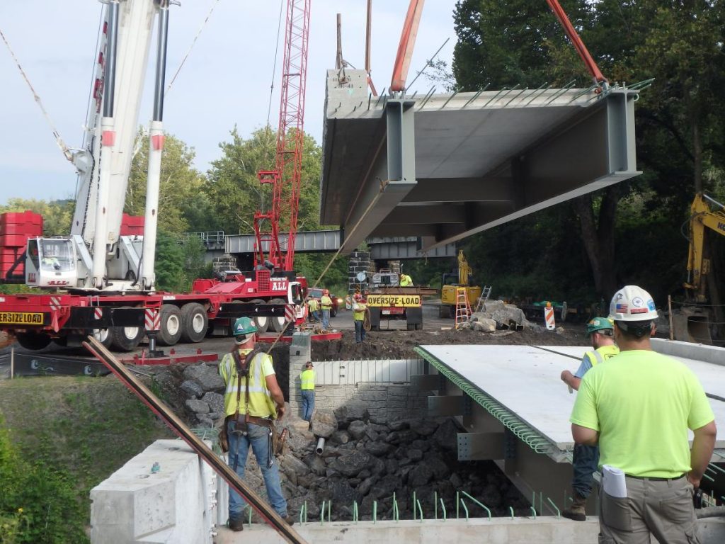 Workers assemble a prefabricated bridge in Pennsylvania, U.S. to replace a structurally deficient bridge