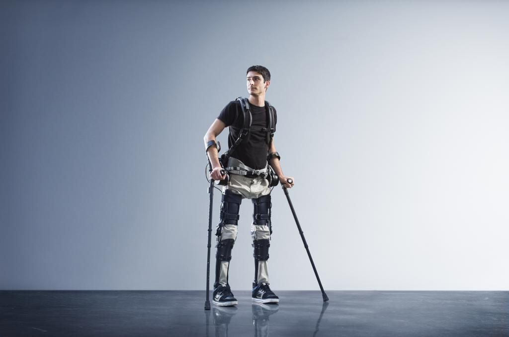 A man walks with the help of the the Phoenix exoskeleton developed by SuitX