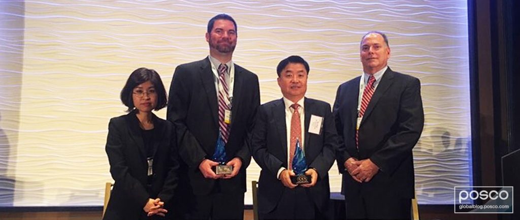 Representatives from POSCO and ExxonMobil hold their Deals of Distinction awards.