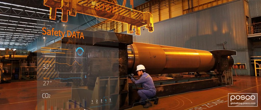A worker kneeling by a machine in POSCO’s smart factory.