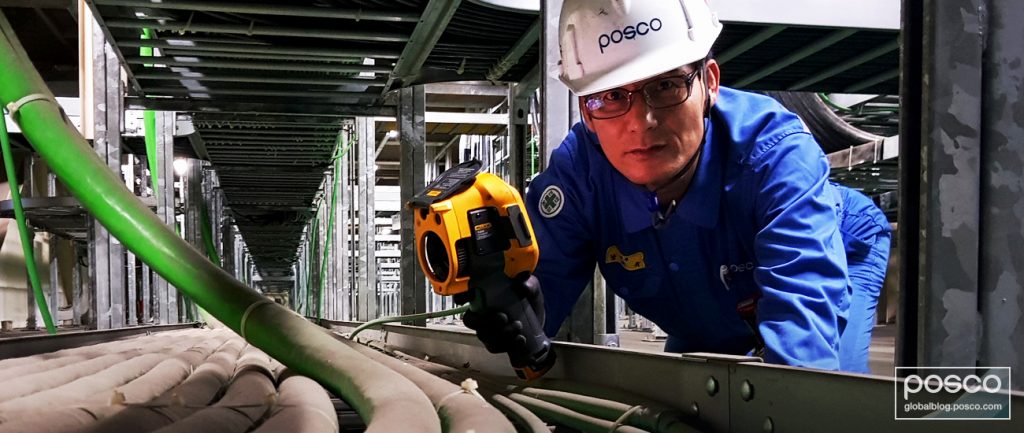 Nam Tae-Gyu examines machinery at a POSCO steel mill.