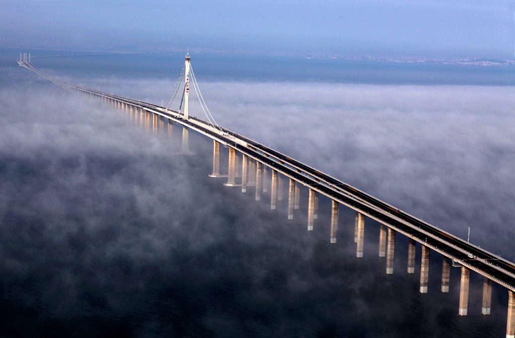 Bird’s eye view of Jiaozhou Bay Bridge in China covered by clouds.