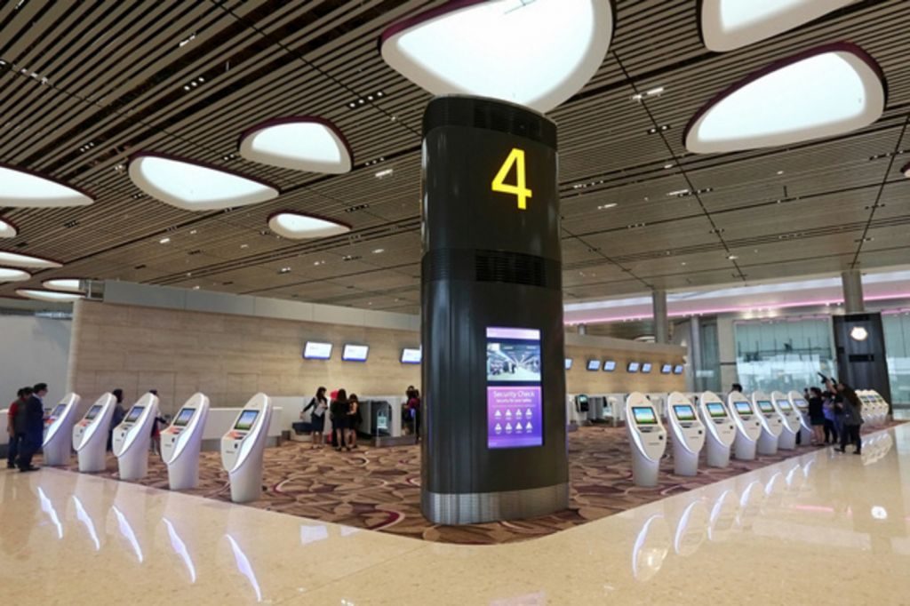 Changi Airport Terminal 4 with self-service kiosks.