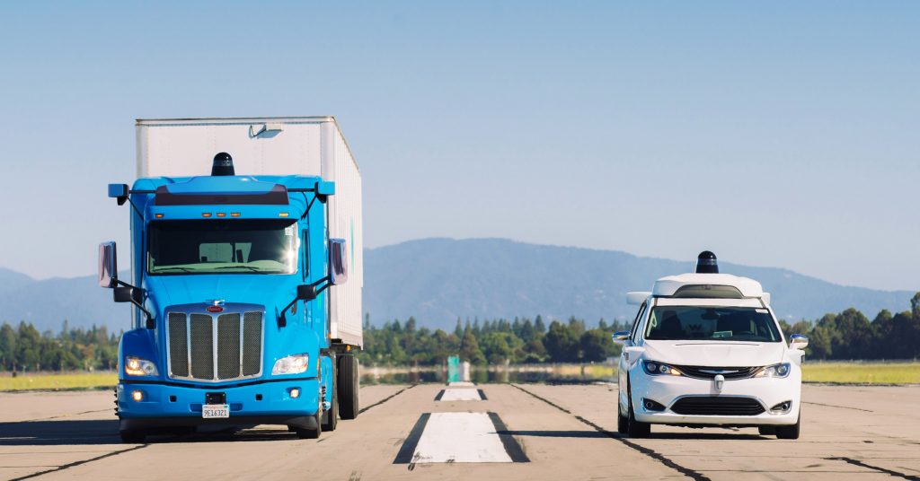 Waymo’s autonomous truck being tested alongside a white van.