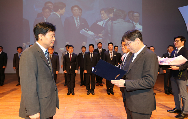 권오준 회장이 박영도 포항 1제선공장장에게 포스코패밀리 기술상 최고의 영예인 혁신상을 수여하고 있다.