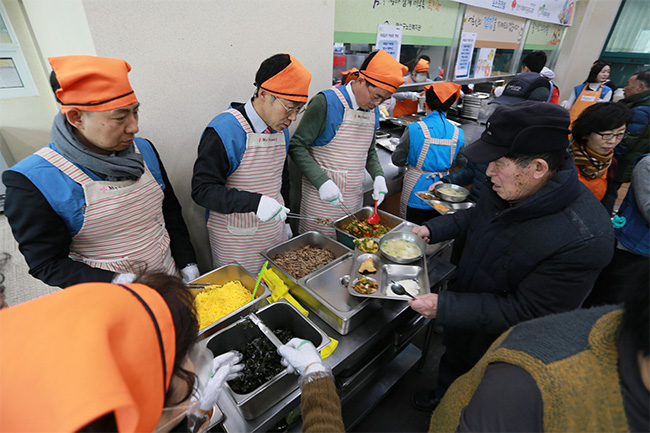 포스코건설 임직원들이 2월 13일 인천 연수구 노인복지관에서 지역 어르신들에게 떡국을 대접하는 모습