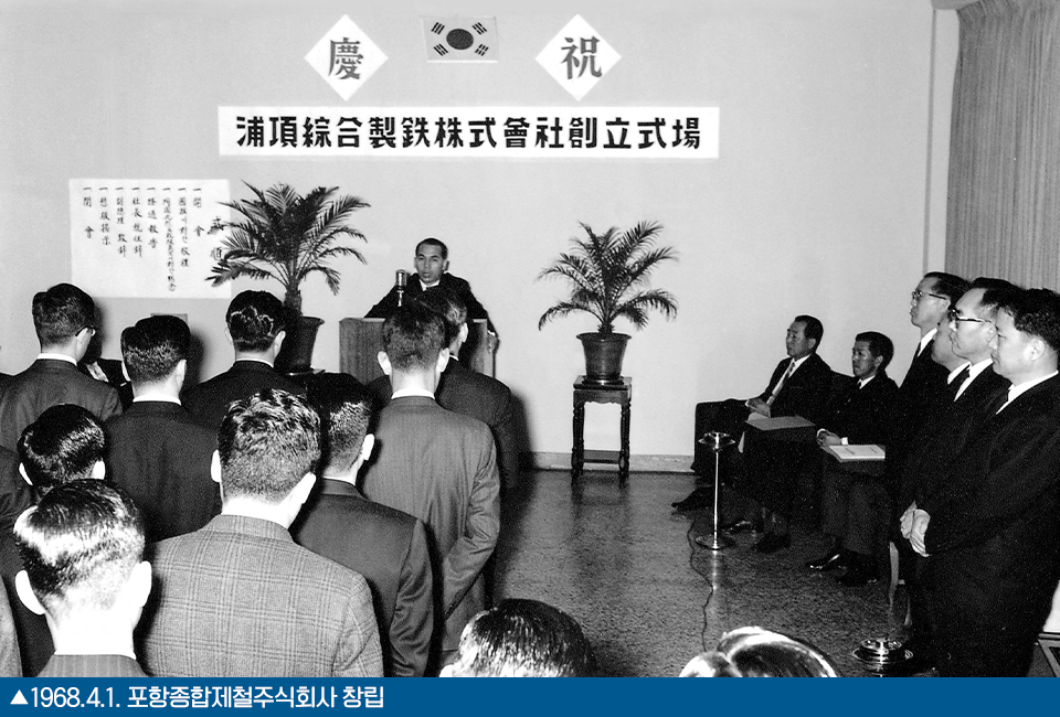 한 남성이 앞에서 연설하고 있고 이를 여러명의 사람들이 경청하고 있는 모습을 찍은 흑백사진으로 하단에는 1968.4.1. 포항종합제철주식회사 창립이라고 쓰여있다.